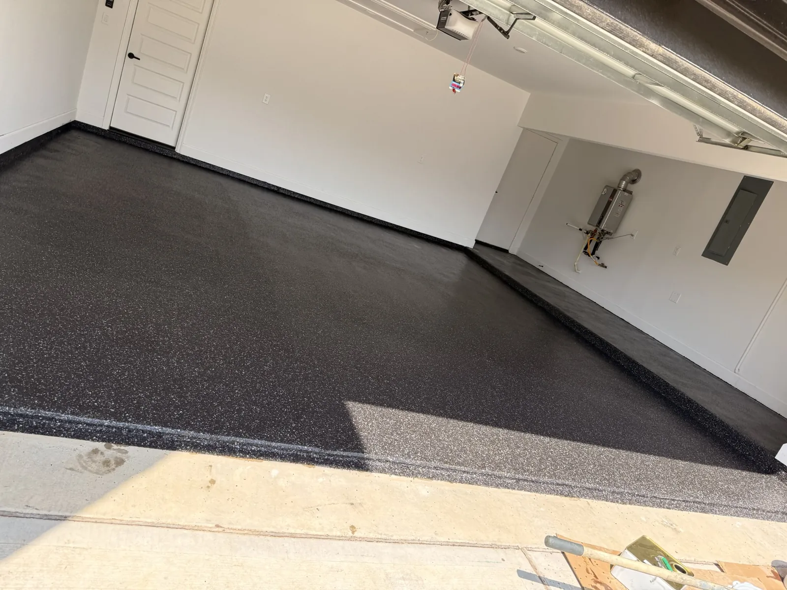 Garage floor coated wall to wall in charcoal flake