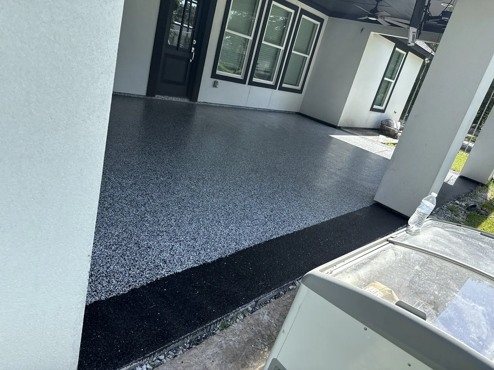 Corner of a covered patio coated in grey flake